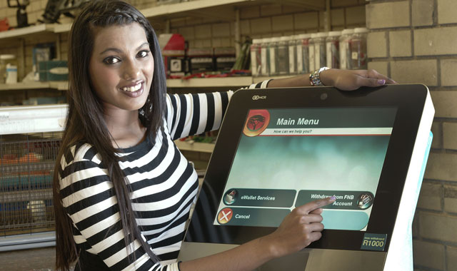A model demonstrates a Slimline ATM installed at a hardware retailer in Midrand, near Johannesburg (image supplied)